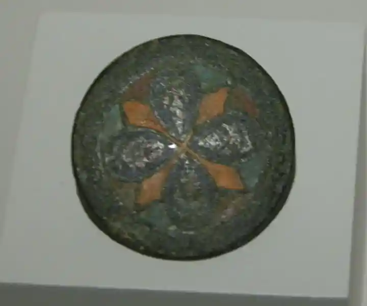 Bronze buckle with a solar symbol in the center